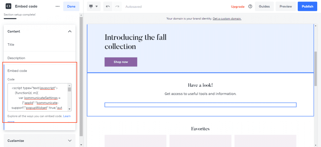 Screenshot of the Weebly website Screenshot of the Weebly website editor showing a page with a header section containing the text "Introducing the fall collection" and a button that says "Shop now." Below the header is a placeholder for more content. There are also buttons for adding sections, editing the website, and managing items. On the left side, there is a sidebar with options for adding customer testimonials, media (photo gallery, video, embed code, embed PDF), and communication. The highlighted section is "Embed code," which displays a code snippet for embedding a Kommunicate chat widget.