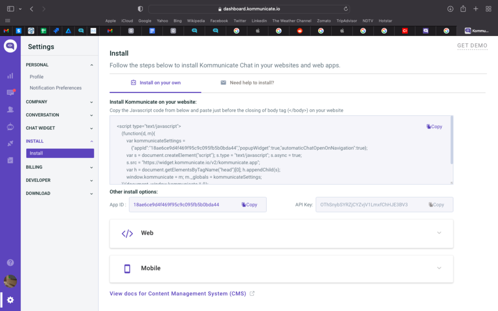 Screenshot of the Kommunicate dashboard showing the "Install" section. The user is instructed to follow the steps below to install Kommunicate Chat in their websites and web apps. The steps include copying the JavaScript code from below and pasting it just before the closing of the body tag on their website. There are also options to install on mobile or view docs for Content Management System (CMS). The dashboard provides the App ID and API key for installation. Screenshot of the Kommunicate dashboard showing the "Install" section. The user is instructed to follow the steps below to install Kommunicate Chat in their websites and web apps. The steps include copying the JavaScript code from below and pasting it just before the closing of the body tag on their website. There are also options to install on mobile or view docs for Content Management System (CMS). The dashboard provides the App ID and API key for installation.